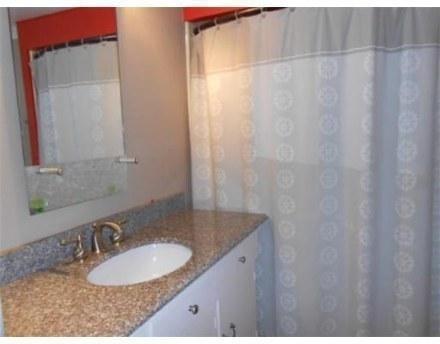 29 Scraggy Neck Road Cataumet, MA 02534 - Photo 12 of 17 a bathroom with a granite countertop sink and a mirror