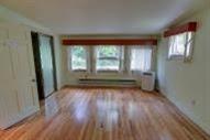 29 Scraggy Neck Road Cataumet, MA 02534 - Photo 16 of 17 an empty room with wooden floor and windows