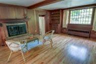 29 Scraggy Neck Road Cataumet, MA 02534 - Photo 8 of 17 a living room with a fireplace furniture and a wooden floor
