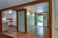 29 Scraggy Neck Road Cataumet, MA 02534 - Photo 9 of 17 a view of a hallway with wooden floor a glass door and a kitchen