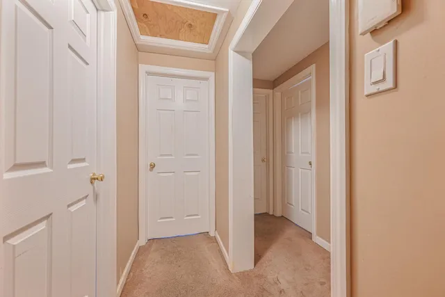 a view of a hallway with closet and door