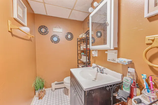 a bathroom with a sink vanity and a mirror