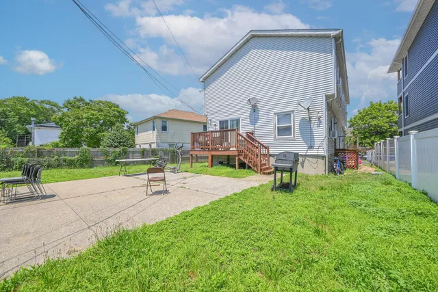 a view of a house with a yard and sitting area