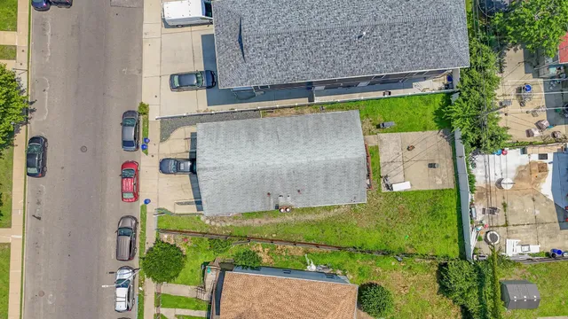 an aerial view of a house with a yard and table and chairs