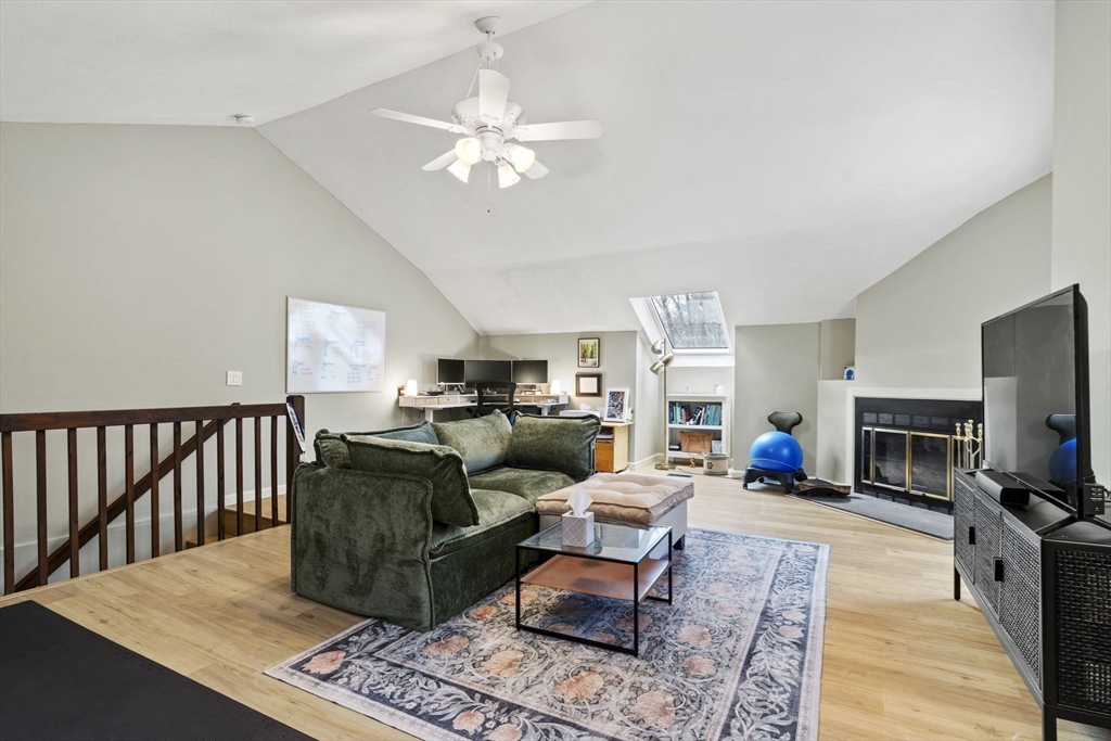 4 Apple Ridge Road, Unit 6 Maynard, MA 01754 - Photo 21 of 40 a living room with furniture a fireplace and a flat screen tv