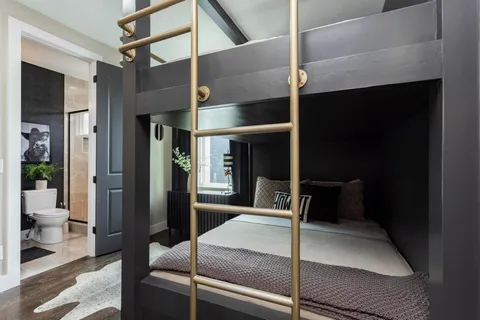 a bathroom with a sink a toilet a mirror and shower