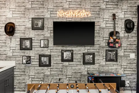 a large white kitchen with a large window a sink and stainless steel appliances