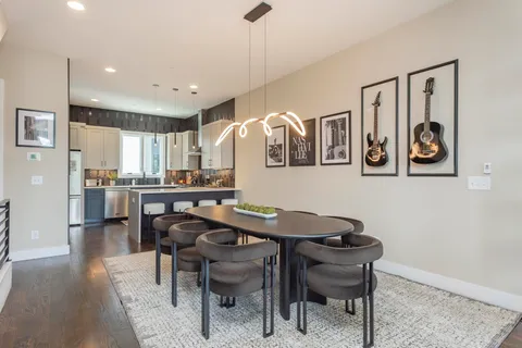 a view of a dining room with furniture and wooden floor