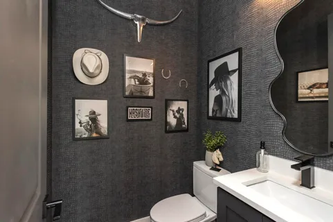 a bathroom with a toilet a sink and mirror