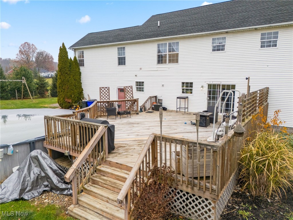 7374 Virginia Road Atwater, OH 44201 - Photo 40 of 49 Rear view of property with a wooden deck and roof with shingles