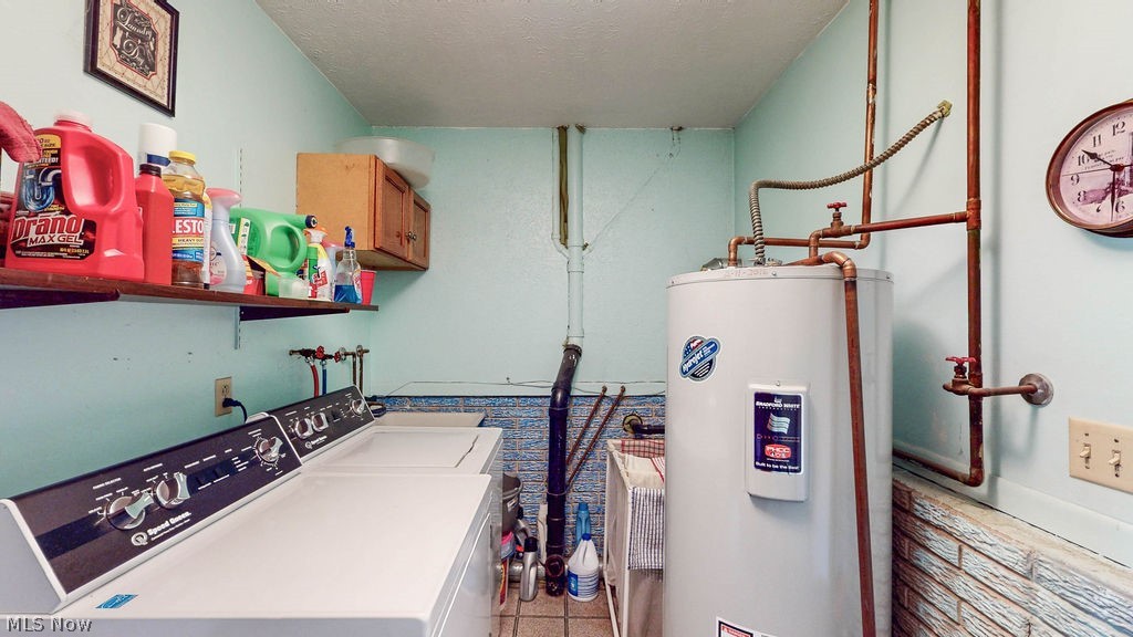 38667 Chestnut Ridge Road Elyria, OH 44035 - Photo 26 of 35 Dedicated utility room featuring a built-in water heater, wall-mounted shelving, overhead cabinetry, and a washer/dryer hookup