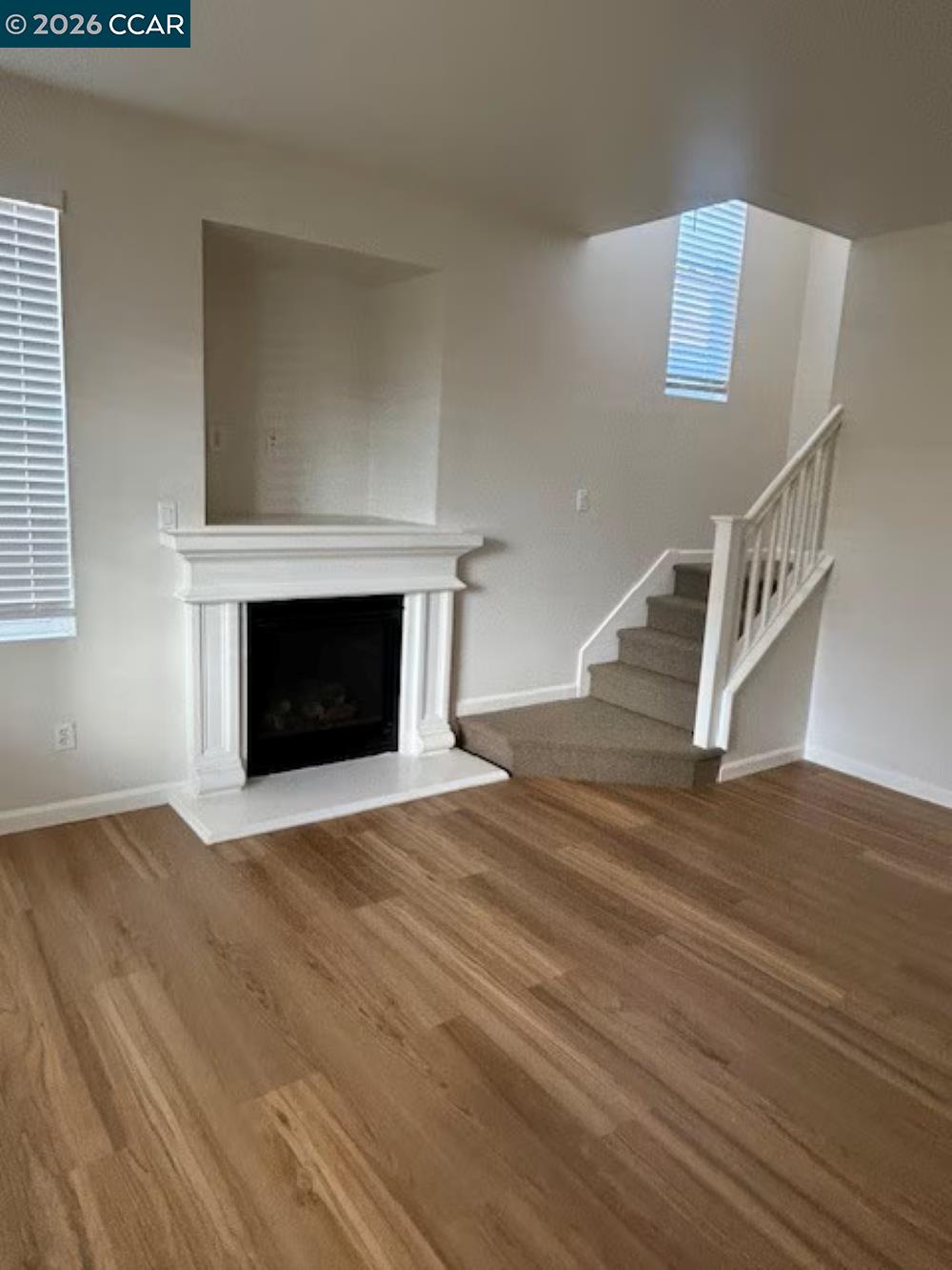 2297 Orleans Street Santa Rosa, CA 95403 - Photo 4 of 30 a view of an empty room with wooden floor fireplace and a window