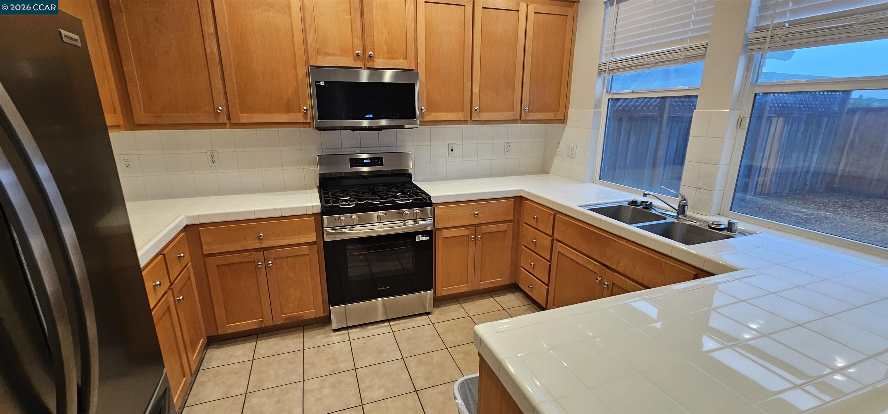 2297 Orleans Street Santa Rosa, CA 95403 - Photo 9 of 30 a kitchen with stainless steel appliances granite countertop a stove a sink and a microwave