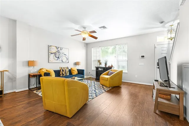 a living room with furniture and a chandelier