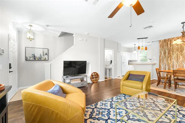 a view of a dining room and kitchen with furniture wooden floor and a chandelier