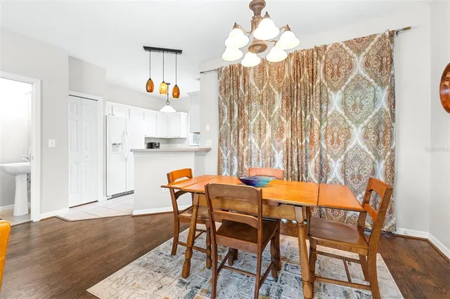 a view of a dining room with furniture and a chandelier