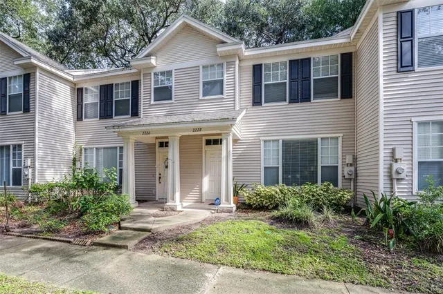 a front view of a house with yard and trees