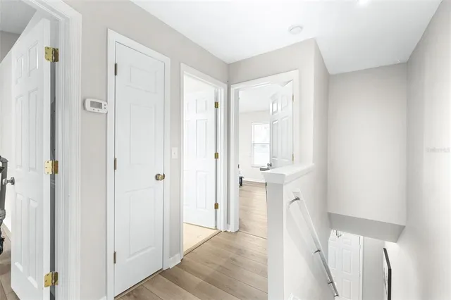 a bedroom with a bed and a flat tv screen on wall