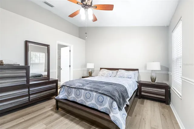 a view of a room with wooden floor and windows