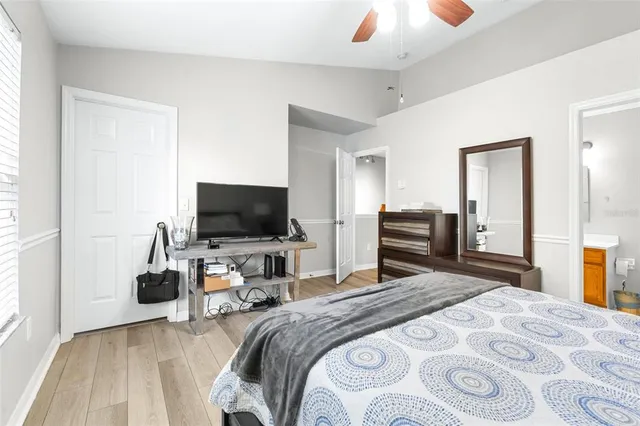 an empty room with wooden floor and closet