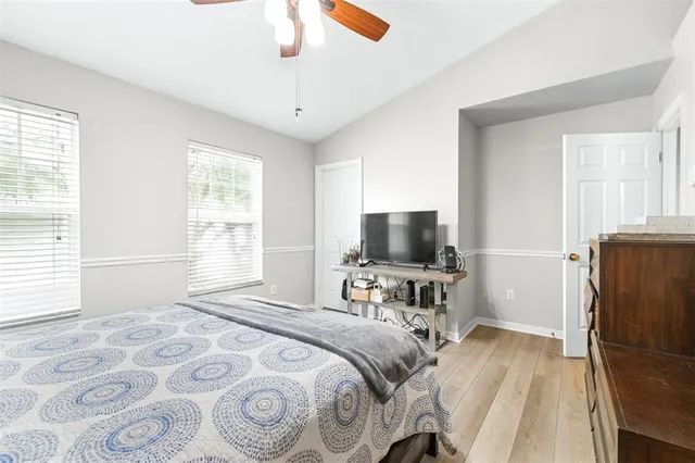 a view of a bedroom with a bed and a window