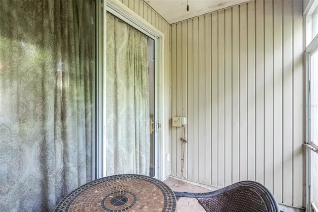 a backyard of a house with plants and barbeque oven