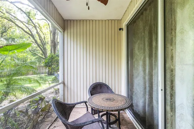 a backyard of a house with lots of plants and tree