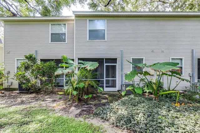 an aerial view of a house with swimming pool and outdoor seating