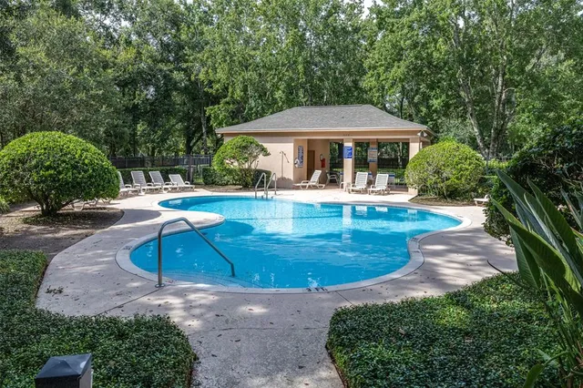an aerial view of a house with a yard and outdoor seating