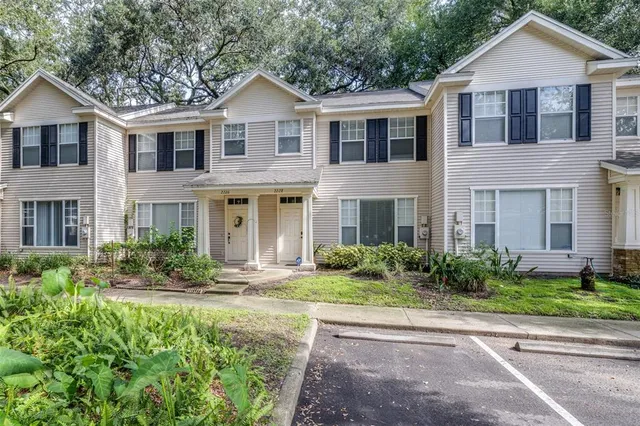 a front view of a house with yard and green space