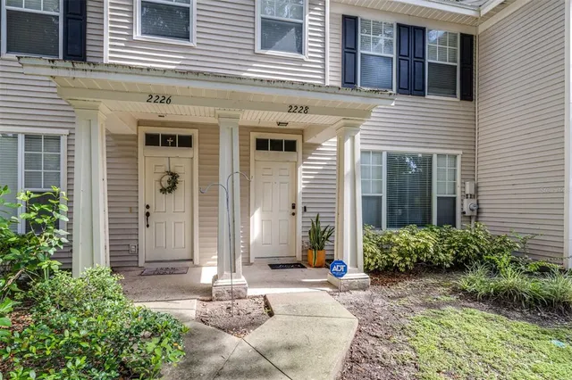a living room with furniture and a hard wood floor