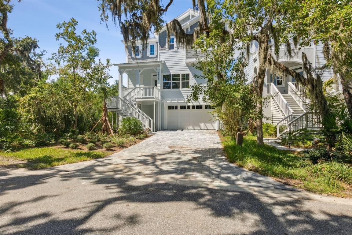 96606 Compass Point Drive Fernandina Beach, FL 32034 - Photo 3 of 88 a front view of a house with a yard and trees