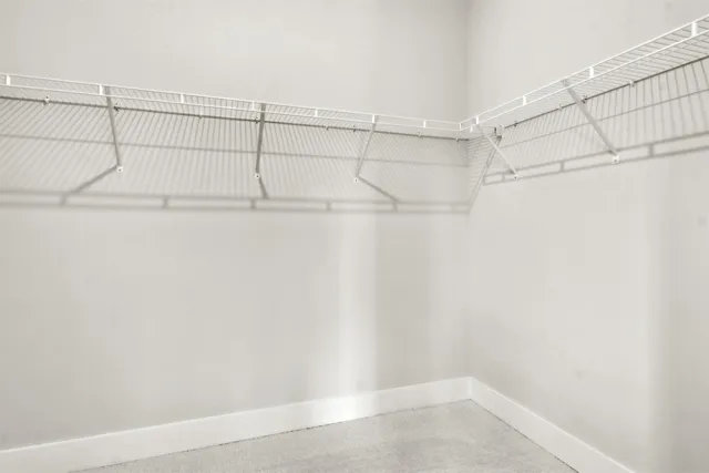 an aerial view of a house with a yard and trees all around