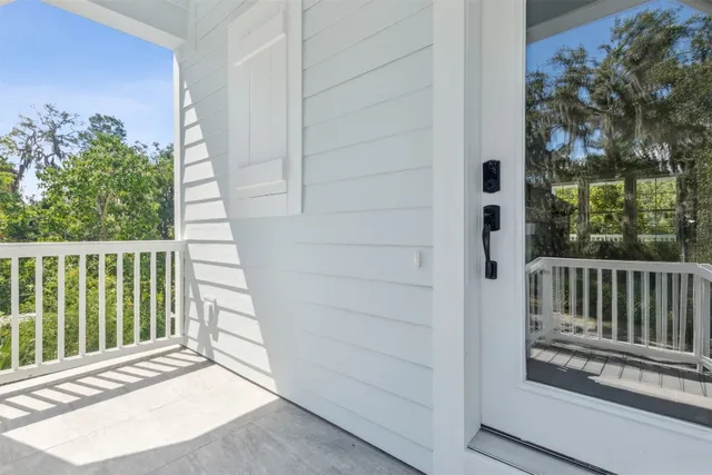 a view of a room with balcony and floor to ceiling window