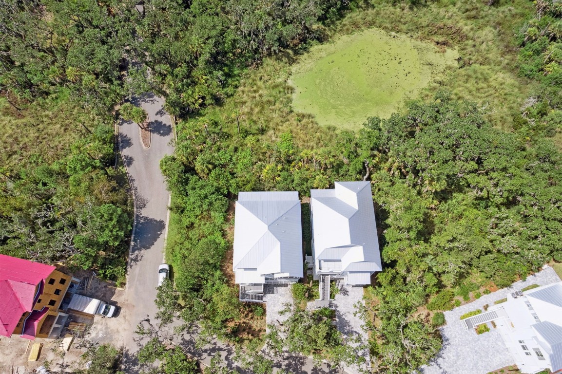 96606 Compass Point Drive Fernandina Beach, FL 32034 - Photo 47 of 88 an aerial view of a house with a yard and trees all around