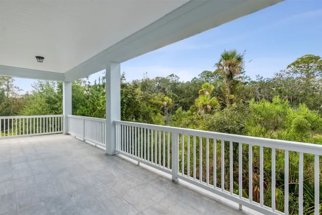 a view of an empty room with a window and fireplace