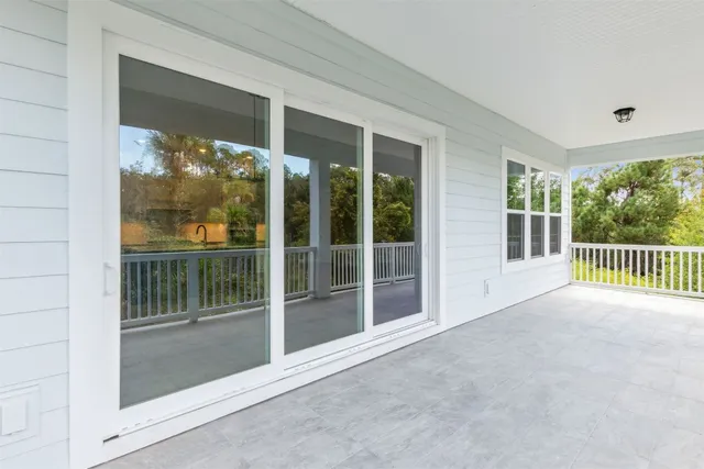 a large kitchen with kitchen island granite countertop a stove top oven a sink a counter space and cabinets