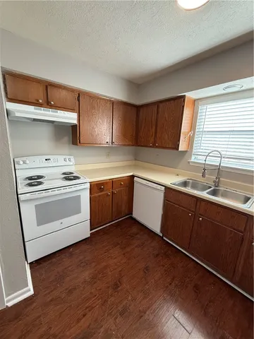 a kitchen with a white cabinets and white appliances