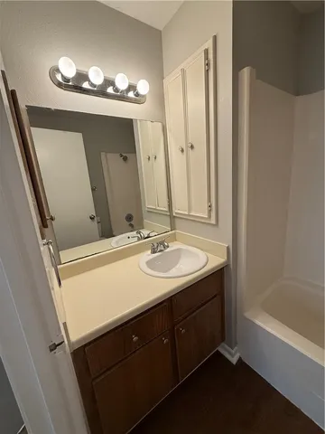 a bathroom with a double vanity sink and a mirror