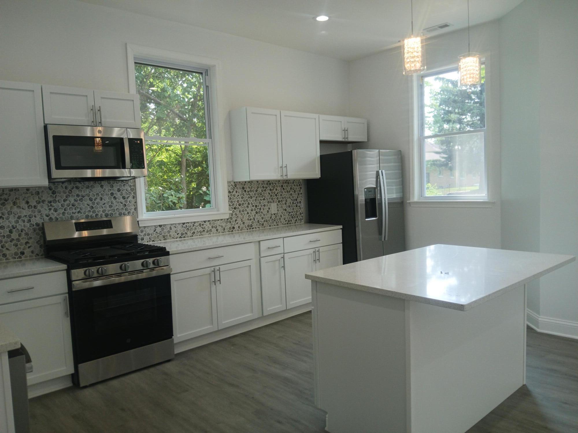 4365 Adams Street Gary, IN 46408 - Photo 21 of 68 a kitchen with a stove a sink and a refrigerator