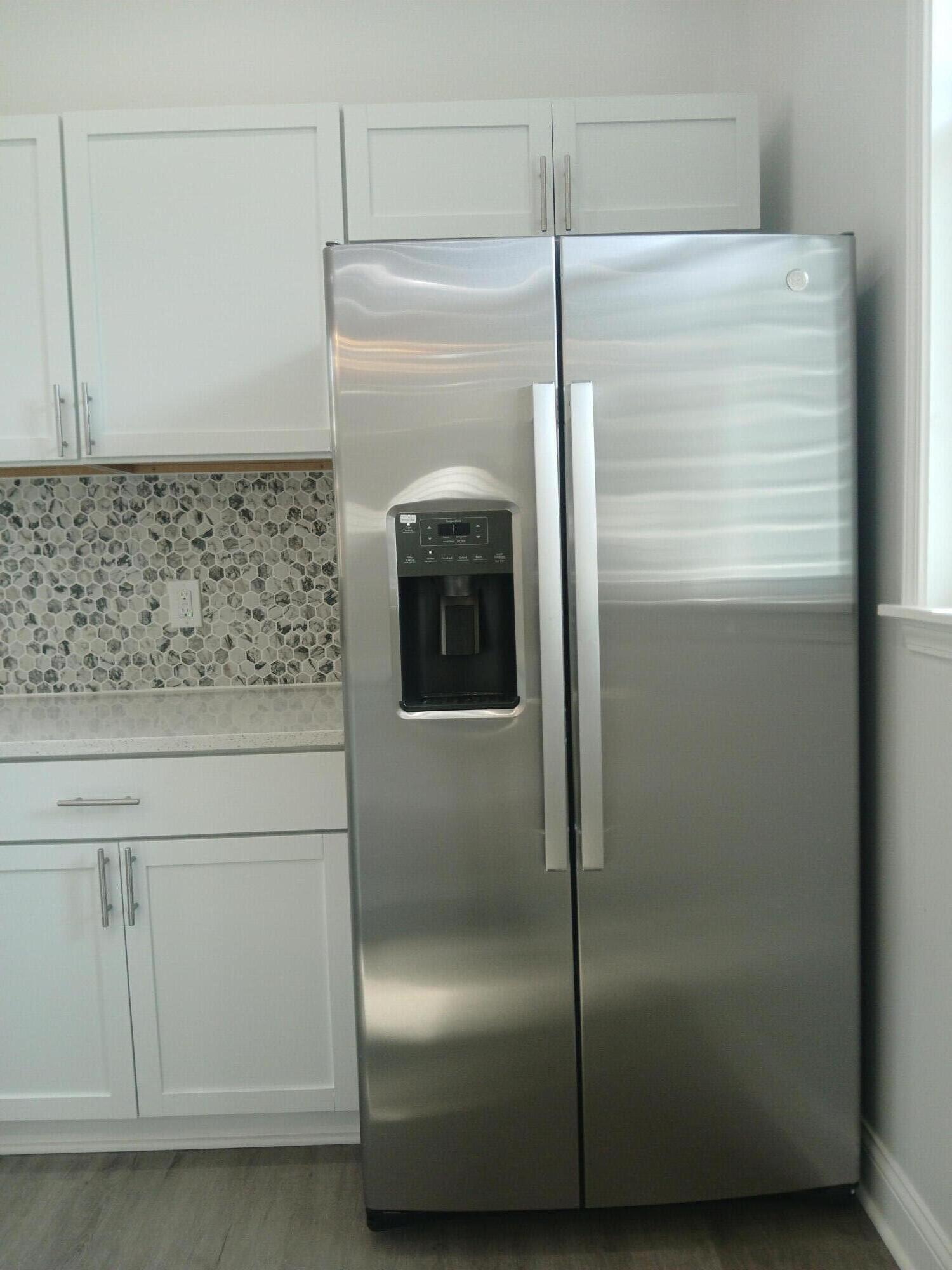 4365 Adams Street Gary, IN 46408 - Photo 23 of 68 a kitchen with metallic refrigerator freezer and a dishwasher