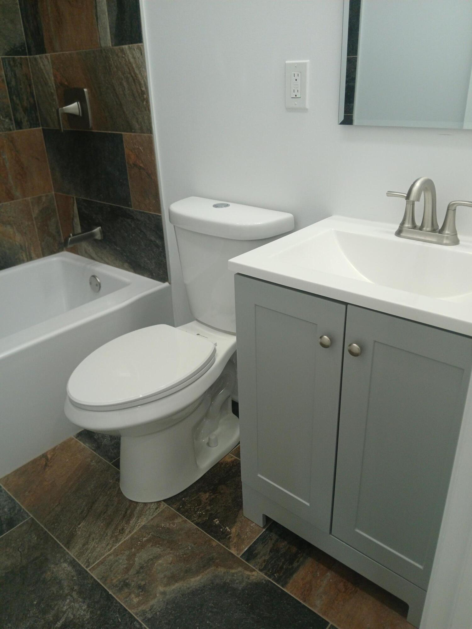 4365 Adams Street Gary, IN 46408 - Photo 24 of 68 a white toilet sitting next to a bathroom sink