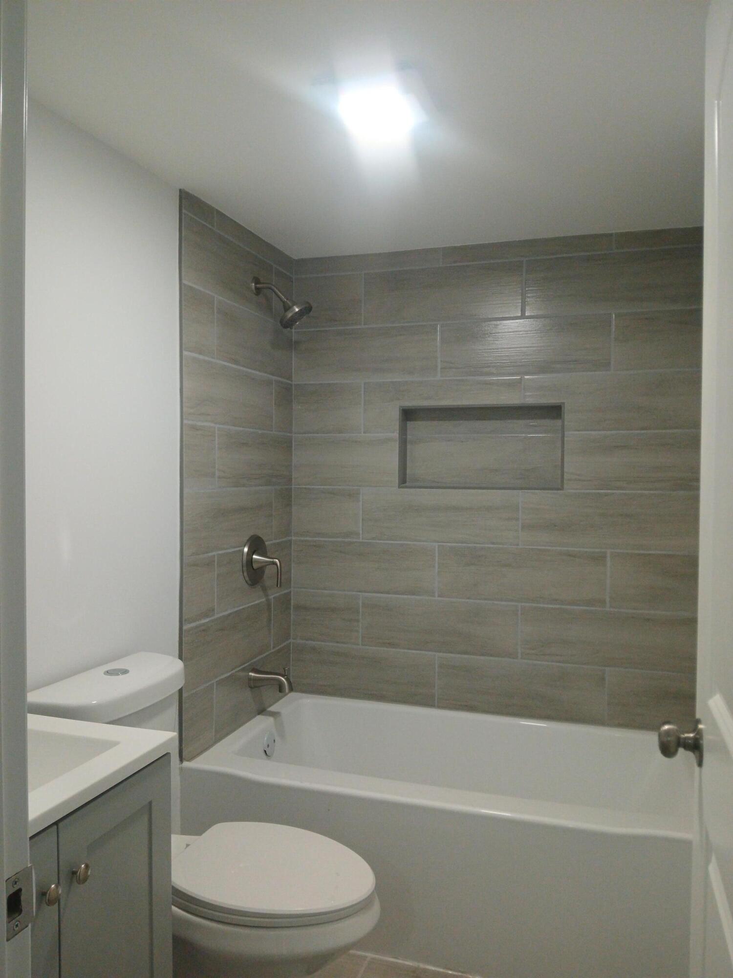 4365 Adams Street Gary, IN 46408 - Photo 26 of 68 a bathroom with a bathtub and a toilet