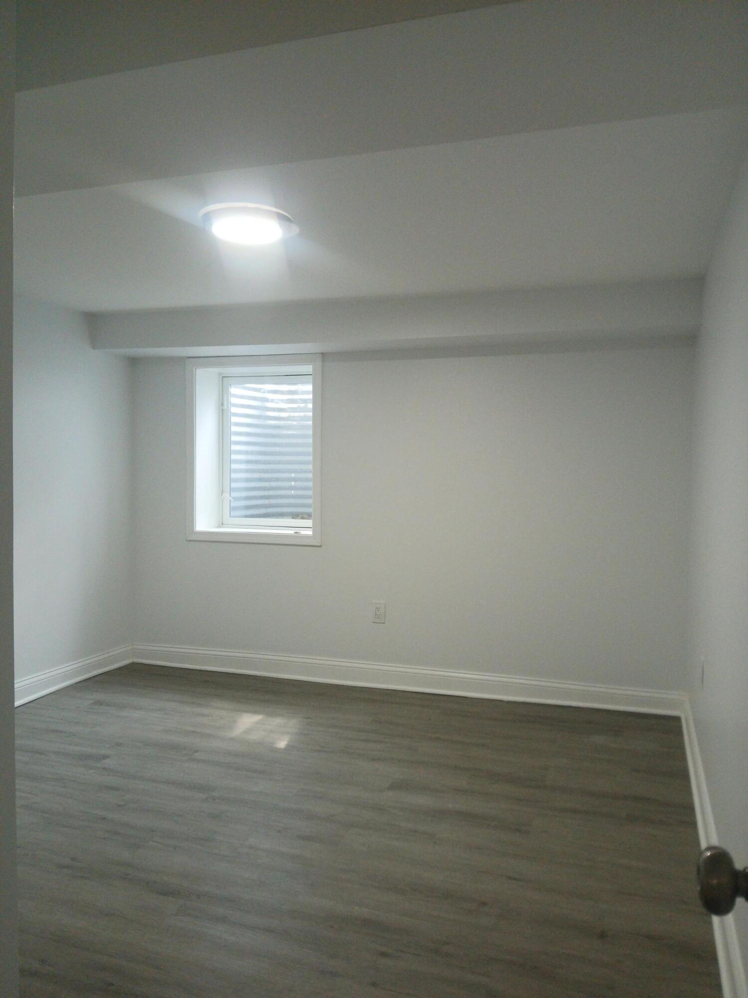 4365 Adams Street Gary, IN 46408 - Photo 29 of 68 a view of an empty room with wooden floor and a window
