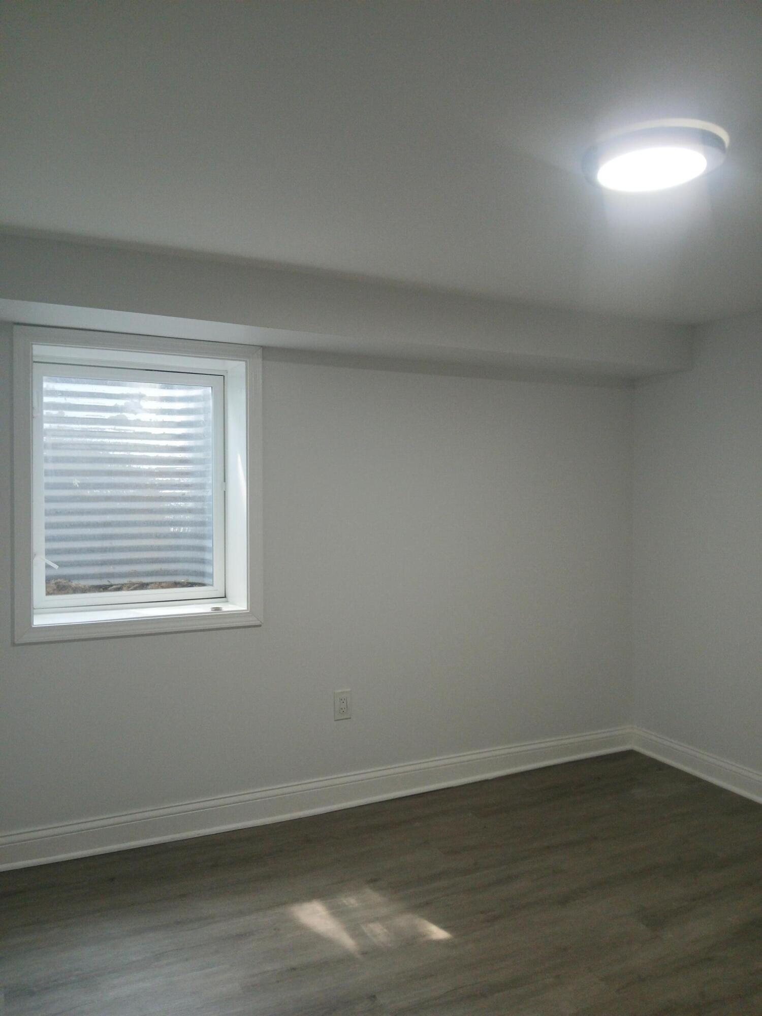 4365 Adams Street Gary, IN 46408 - Photo 37 of 68 a view of an empty room with wooden floor and a window
