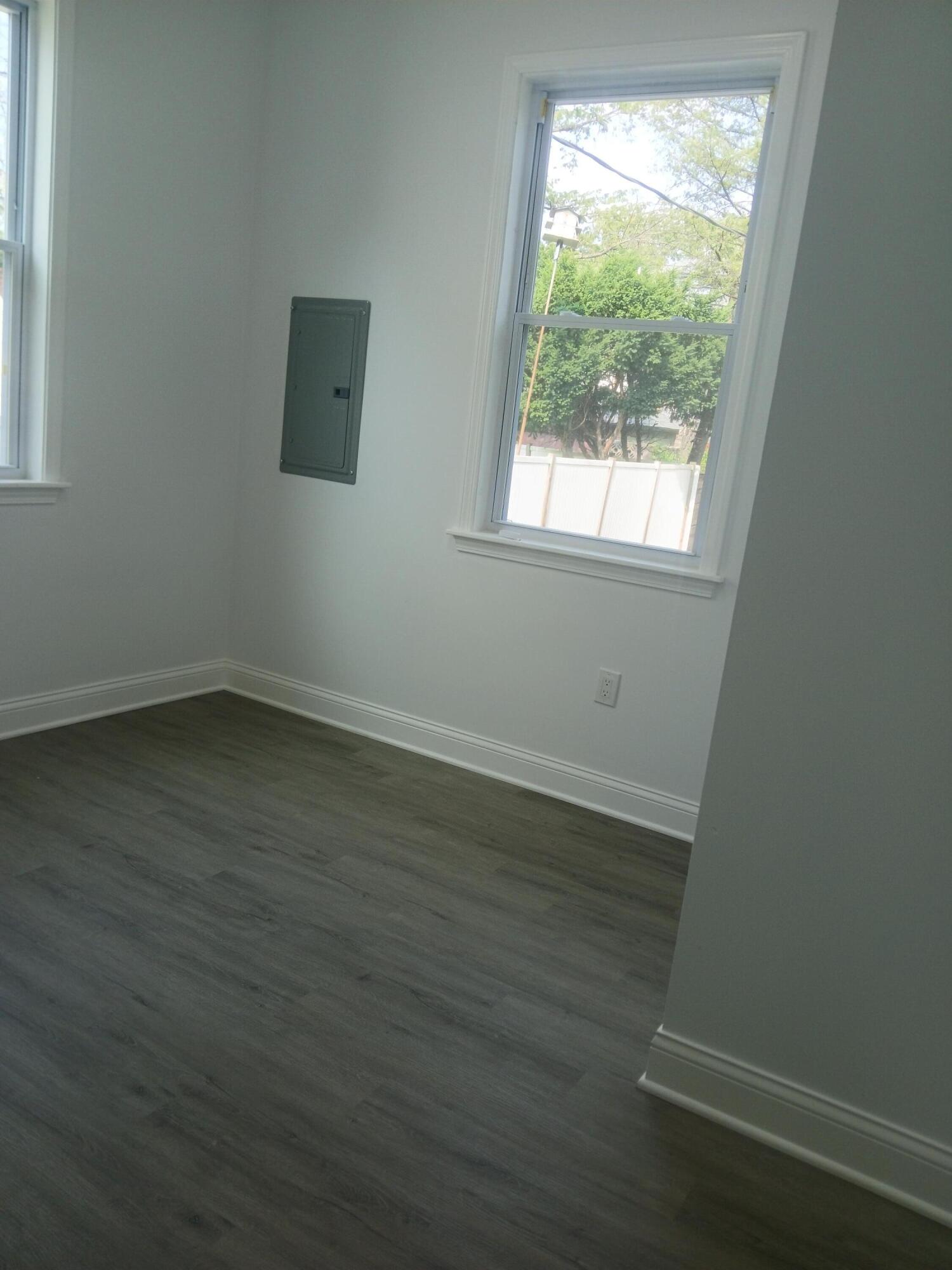 4365 Adams Street Gary, IN 46408 - Photo 46 of 68 an empty room with wooden floor and windows