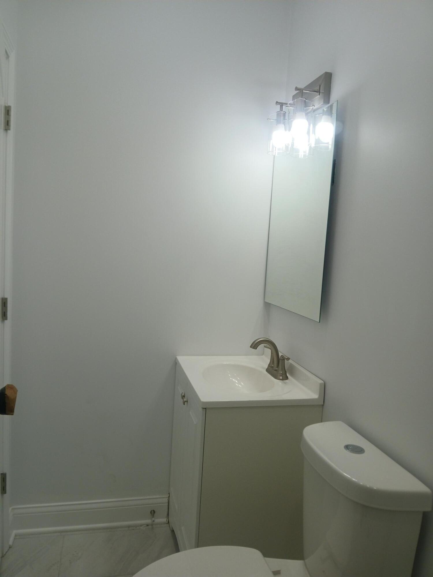 4365 Adams Street Gary, IN 46408 - Photo 53 of 68 a bathroom with a toilet sink and mirror