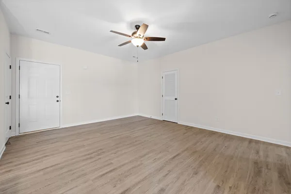 a kitchen with stainless steel appliances granite countertop a sink a stove a refrigerator and island with wooden floor