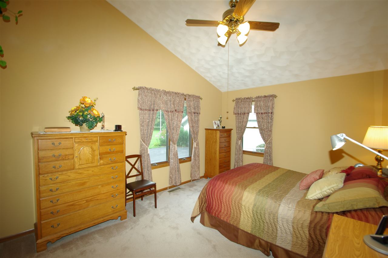 8638 Rote Road Rockford, IL 61107 - Photo 12 of 25 a bedroom with a bed and ceiling fan