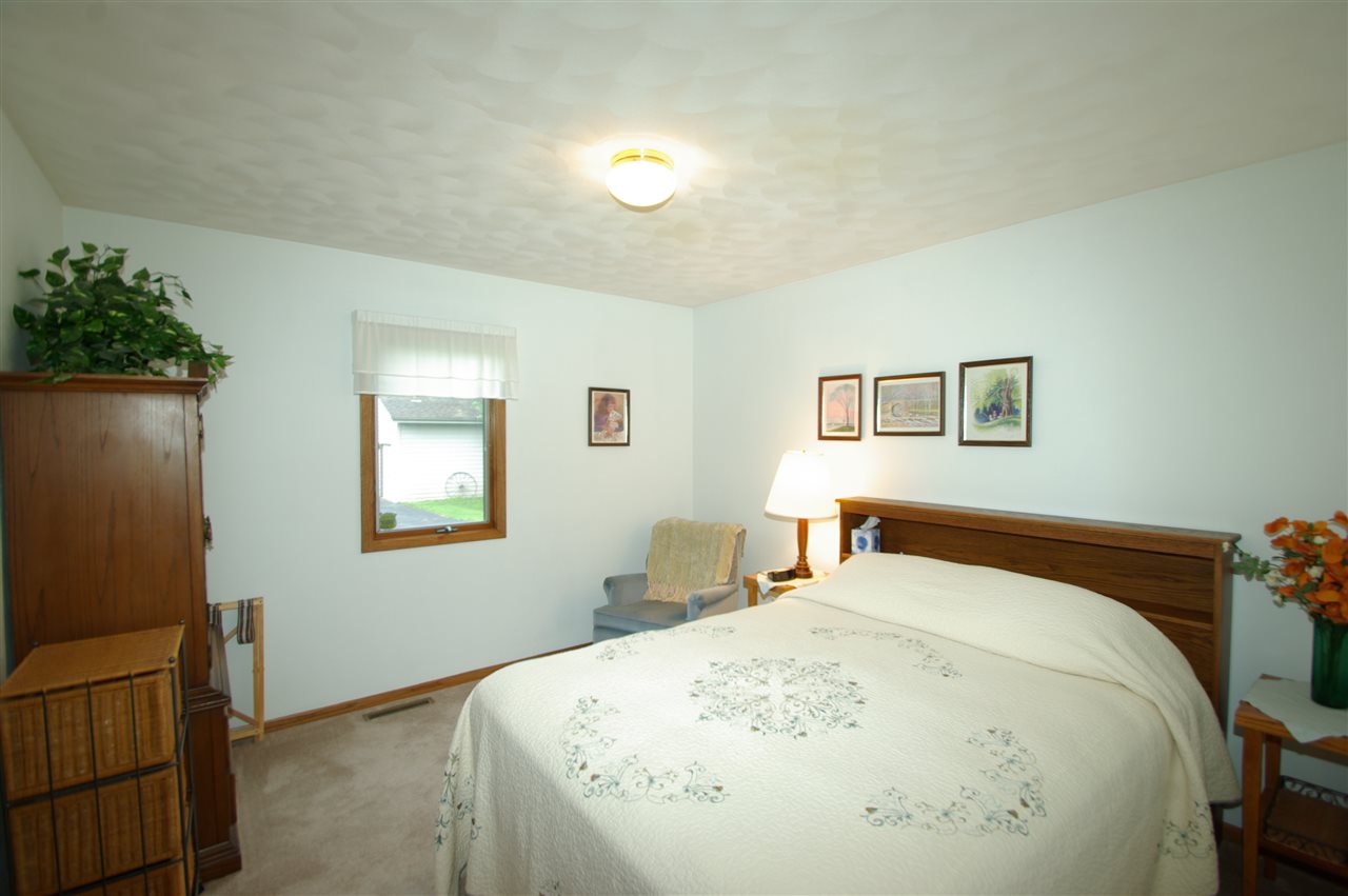 8638 Rote Road Rockford, IL 61107 - Photo 16 of 25 a bedroom with a bed and a potted plant